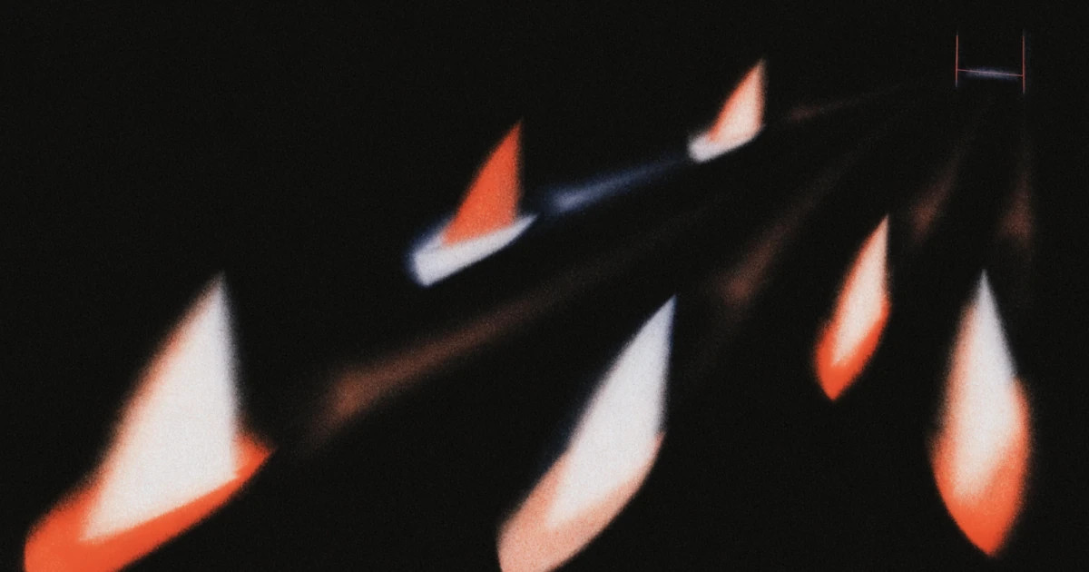 Paper boat sails caught mid-motion against black, some lit white and some vermilion, trailing streaks of light.